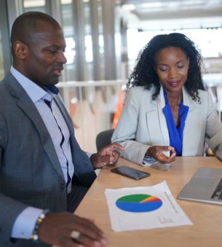 young man consulting his business partner at meeting in office