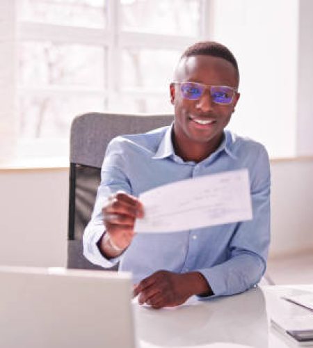 holding paycheck or payroll check or insurance cheque in hand