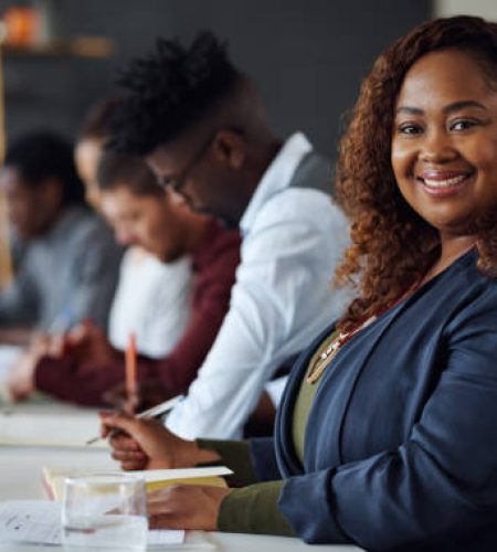 portrait of a young businesswoman working alongside her colleagues in an office