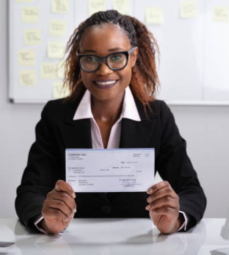 close up of a smiling businesswoman showing company cheque